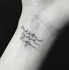 a small wrist tattoo with the words love and life written in cursive font