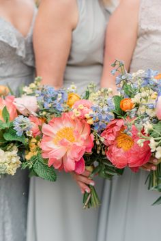 the bridesmaids are holding their bouquets with different colored flowers in each one