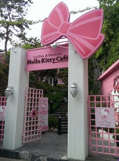 the entrance to hello kitty cafe is decorated in pink and white with a large bow