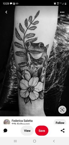 a black and white photo of a tattoo on someone's arm, with flowers