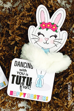 two easter bunny cutouts sitting on top of wood shavings with the words dancing with you is tutu for happy easter