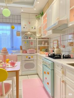 a kitchen filled with lots of white appliances and pink rugs on top of the floor