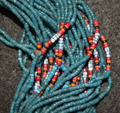 "Antique Necklace 579. Authentic Konyak Naga Long \"Royal\" Chief's Clan, Old blue Glass Trade Bead Necklace with Macrame Clasp and Attached Old Chank Shell Adornment Showing Increased Status. \"Royal\" center of special chevron, mustard, white heart and other beads usually seen in higher status collars, bibs and belts. Excellent condition. The piece has 45 strands of beads and is 32 \"long. Beads all acquired in trade, from Europe and India, from late 19th to mid 20th century. Shell, from the I Artisan Blue Beaded Necklaces For Festivals, Handmade Blue Beaded Necklaces For Festivals, Festival Blue Beaded Necklaces With Colorful Beads, Traditional Blue Beaded Bracelets For Festivals, Blue Beaded Necklaces For Festivals, Blue Beaded Necklaces With Large Beads For Festive Occasions, Festive Blue Beaded Necklaces With Large Beads, Festive Blue Beaded Necklace With Large Beads, Traditional Hand-strung Blue Jewelry