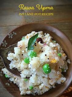 a bowl filled with rice and peas on top of a wooden table