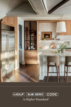 a large kitchen with wooden cabinets and white counter tops is featured in the magazine loft supercove