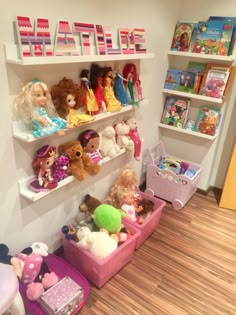 there are many toys on the shelves in this playroom, including dolls and books