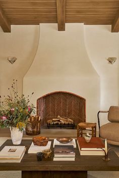 a living room filled with furniture and a fire place next to a wall mounted fireplace