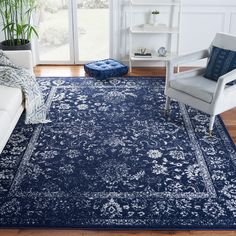 a living room with a blue rug and two chairs