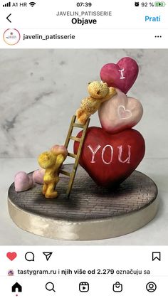 there is a small figurine on top of a heart