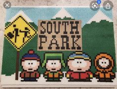 the south park sign is made out of bead and has three people standing in front of it