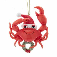 a red crab ornament with a santa hat on it's head hanging from a string