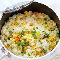 a pot filled with rice and vegetables on top of a table