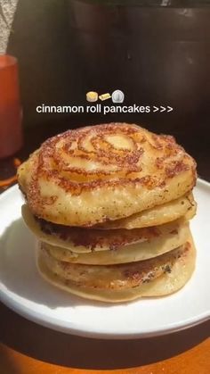 a stack of pancakes sitting on top of a white plate