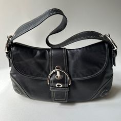 Coach Soho Style F10192 Black Leather Hobo Shoulder Bag Vintage Y2k Great Condition, With Minor Scratches/Scuffs Beautiful Vintage Coach Soho Shoulder Bag. The Black Leather Exterior Is Accented With A Buckle Detail And Zipper Closure. Measurements Approximately: 12 Inches In Width, 9 Inches In Height, And 3 Inches In Depth. Adjustable Shoulder Strap Silver Color Hardware Coach Shoulder Bag Black, Leather Satchel Baguette Bag With Branded Hardware, Shopping Leather Baguette Bag With Branded Hardware, Leather Baguette Bag With Branded Hardware For Shopping, Leather Baguette Bag With Branded Hardware And Double Handle, Black Satchel Bag With Branded Hardware, Black Baguette Bag Satchel With Silver-tone Hardware, Leather Baguette Shoulder Bag With Branded Hardware, Black Baguette Bag With Branded Hardware For Travel