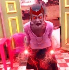 an animated image of a demon with red eyes and glowing lights in front of him