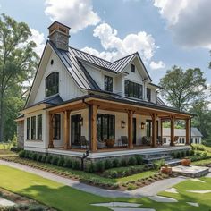 a large white house with lots of windows on the front and side of it's porch