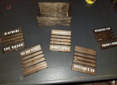 four wooden crates with words written on them sitting on a table next to each other