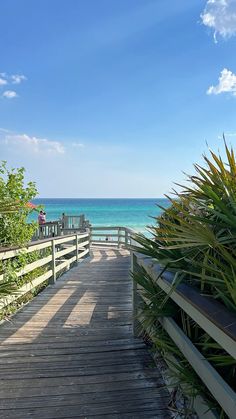 a wooden walkway leading to the ocean