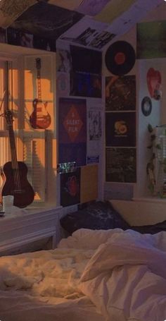 a bedroom with a guitar hanging from the ceiling