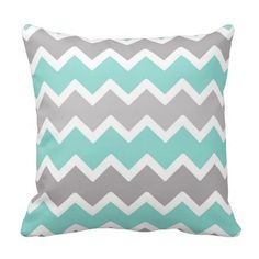 a gray and blue pillow with white chevrons