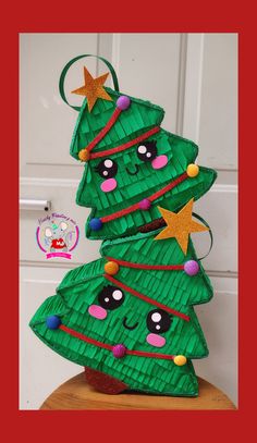 a paper plate christmas tree sitting on top of a wooden table