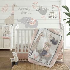 a baby crib bedding set with an elephant and giraffe design on it