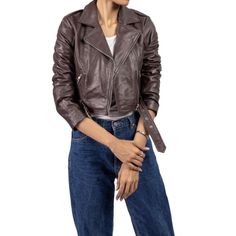 Elevate your wardrobe with our Chic Women's Cropped Leather Jacket. This stylish and versatile outerwear piece is designed for the modern woman who values both fashion and function. Crafted from premium, supple leather, this jacket offers a sleek silhouette that enhances any outfit, whether casual or sophisticated. The cropped cut provides a contemporary twist on the classic leather jacket, making it perfect for layering over dresses, blouses, or even a simple tee. Featuring a tailored fit, zipp Chic Leather Jacket With Long Sleeves, Chic Long Sleeve Leather Jacket, Leather Cropped Jacket With Zipper Closure, Sleek Brown Leather Jacket For Fall, Sleek Brown Leather Outerwear, Fall Leather Cropped Jacket With Zipper Closure, Fall Leather Cropped Jacket With Zipper, Leather Cropped Jacket With Zipper For Fall, Winter Leather Cropped Jacket For Workwear