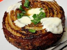 a close up of a plate of food with meat and sauce on it's side