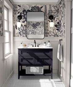 a bathroom with two sinks and a large mirror on the wall next to it is decorated in black and white flowers