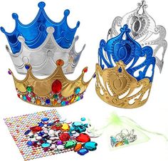 two crowns are next to each other on a white surface with beads and jewels around them