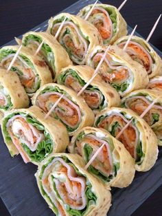 a platter filled with sandwiches and toothpicks