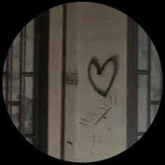 a black and white photo with a heart drawn on the side of a building door