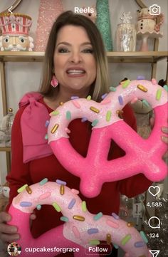 a woman holding up two giant donuts in front of her face and the caption reads, i love doughnuts