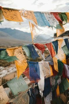 many colorful flags are hanging in the wind