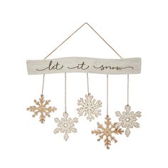 snowflakes hanging from a wooden sign that says let it snow