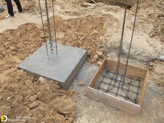 two concrete blocks with wires attached to them on the ground in front of a construction site