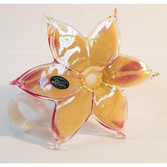 a flower shaped glass object sitting on top of a table