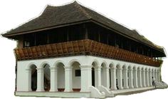 a white building with wooden balconies on the roof