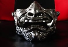 a metal mask sitting on top of a table