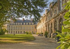 a large building with lots of trees in front of it