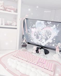 a desk with a keyboard, mouse and various figurines