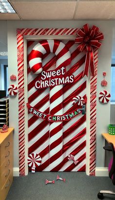 an office decorated for christmas with candy canes on the door and sweet christmas decorations