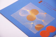 an orange and blue brochure with hearts on it's front cover sitting on a white surface