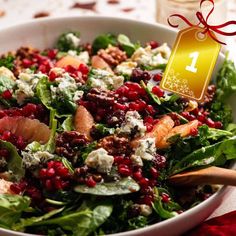 a salad with spinach, feta cheese and pomegranate