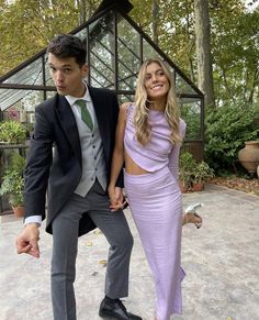 a young man and woman dressed in formal wear