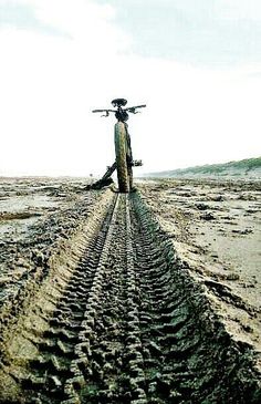 a man standing on top of a dirt covered field