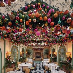 an elaborately decorated dining room with tables and chairs is featured in this image, surrounded by festive decorations