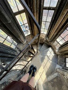 a person standing on top of a set of stairs with their feet in the air