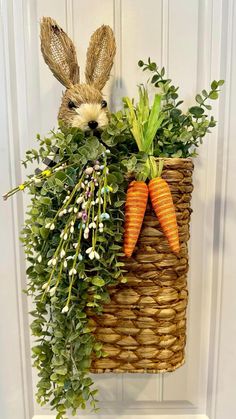 a basket filled with carrots and greenery hanging on a door handle that says, my spring, easter decor hanging