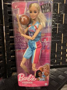 the barbie doll is holding a basketball in her hand and wearing blue shorts with pink trim